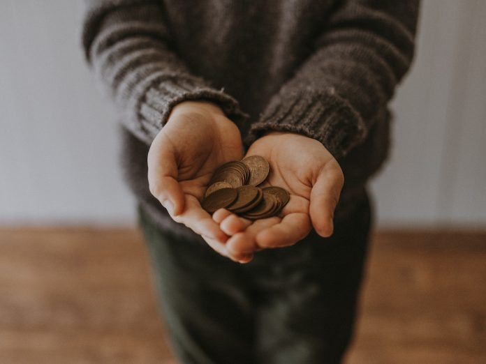 copper-colored coins on in person's hands