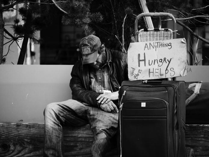 grayscale photography of man sitting on chair