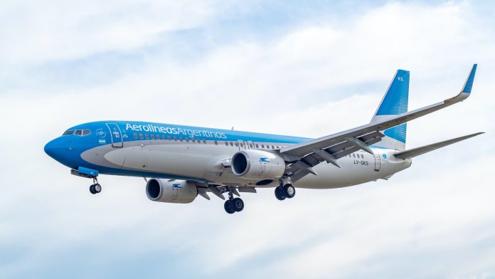 blue and white airplane flying during daytime