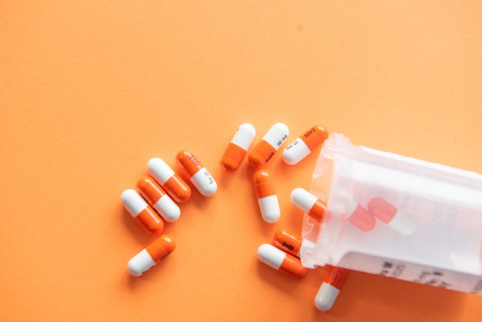 orange and white medication pill